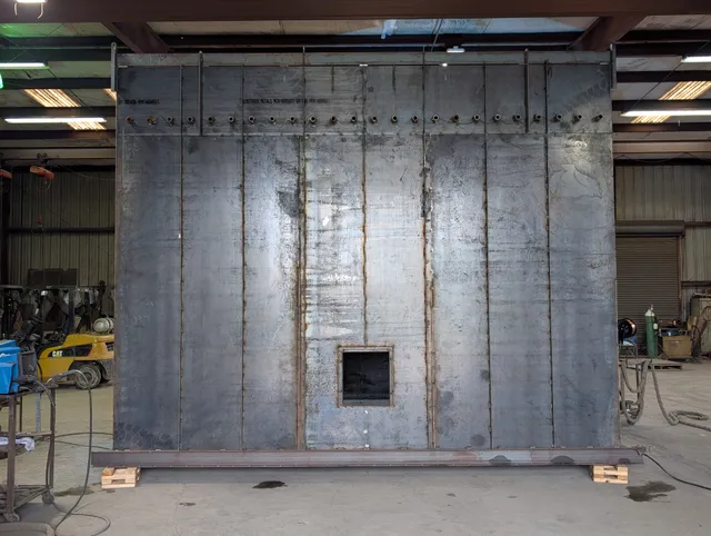 Large flat steel wall panel with vertical stiffeners welded in the fabrication shop